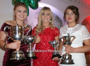 Vice Captain Laura Connolly and Captain Emma McMullan receive the trophies the Senior Camogs collected this year