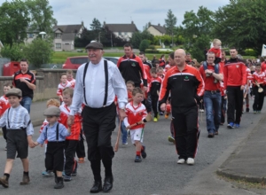 BRENDAN MCGARRY PAST HURLER LEADING THE PAGEANT IN PERIOD COSTUME WITH HIS GRANDSONS